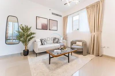 a living room with a couch and a table at City View 2BR Just Steps from the Mall, Roxana Residence B, Jumeirah Village Circle by Deluxe Holiday Homes in Dubai