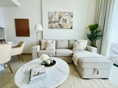 a living room with a couch and a coffee table at Stylish 1br In Jvc Balcony, Pool & Free Parking in Dubai