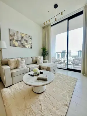 a living room with a couch and a table at Stylish 1br In Jvc Balcony, Pool & Free Parking in Dubai