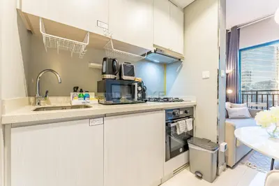 a kitchen with a sink and a microwave at Dubai Canal and City Views 1BR, Minutes Drive to Burj Khalifa, DAMAC Zada Tower, Business Bay by Deluxe Holiday Homes in Dubai