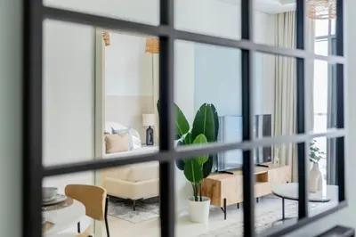 a living room with a view through a window at GuestReady - Elegant city escape in Business Bay in Dubai
