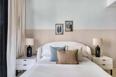 a bedroom with a white bed with two night stands at GuestReady - Elegant city escape in Business Bay in Dubai