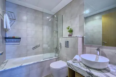 a bathroom with a sink and a toilet and a tub at GuestReady - Elegant city escape in Business Bay in Dubai