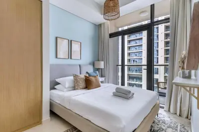 a bedroom with a large bed and a large window at GuestReady - Elegant city escape in Business Bay in Dubai