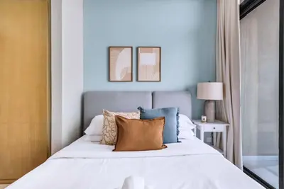 a bedroom with a large bed with blue walls at GuestReady - Elegant city escape in Business Bay in Dubai
