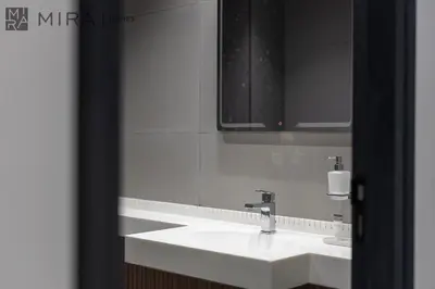 a bathroom with a white sink and a mirror at Mira Holiday Homes - Newly and modern 1 bedroom with lake view in JLT in Dubai