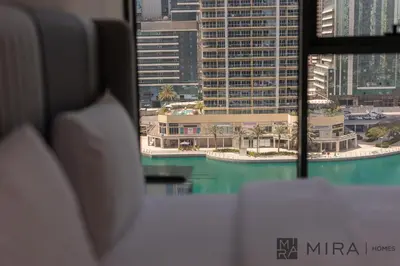 a view of a city skyline from a window at Mira Holiday Homes - Newly and modern 1 bedroom with lake view in JLT in Dubai