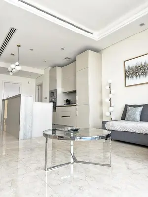 a living room with a glass table and a couch at AURA -Direct Seafront 2BR-Palm in Dubai