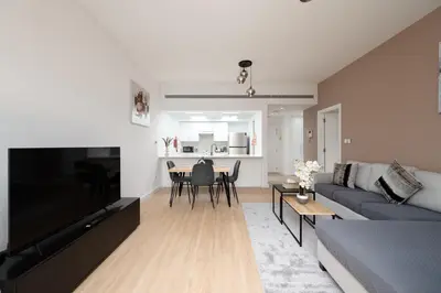 a living room with a couch and a dining room at Serene Getaway in Dubai