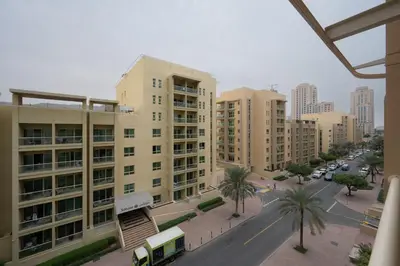 a city with tall buildings and a street with a bus at Serene Getaway in Dubai