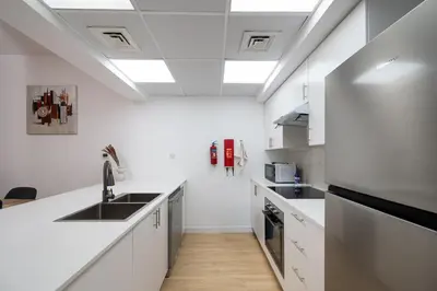 a kitchen with white counters and a sink at Serene Getaway in Dubai