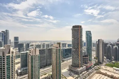 an aerial view of a city with tall buildings at Frank Porter - Burj Royale in Dubai