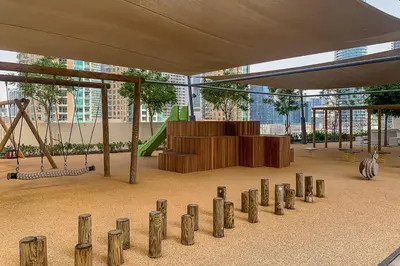a playground with a swing set at Frank Porter - Burj Royale in Dubai