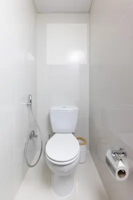 a white bathroom with a toilet and a shower at Luxe 2BR Dubai Retreat with Ain Dubai View for 6 guests in Dubai