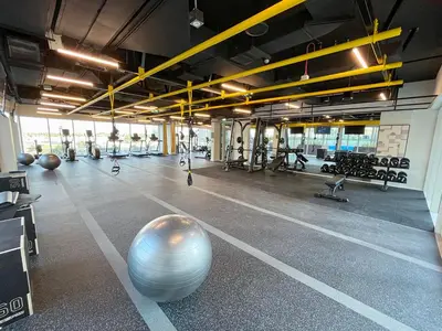 an empty gym with a large exercise ball in the middle at Cozy 1BR in Socio Dubai Hills Near Mall and Park in Dubai