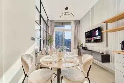 a dining room with a table and chairs at Cozy 1BR in Socio Dubai Hills Near Mall and Park in Dubai