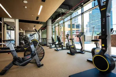a gym with a bunch of exercise bikes in a building at High Floor Burj and Canal View Business Bay in Dubai