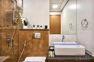 a bathroom with a sink and a shower at Boho-Chic Comfort - 1BR Haven - Marquis 2020 Arjan in Dubai