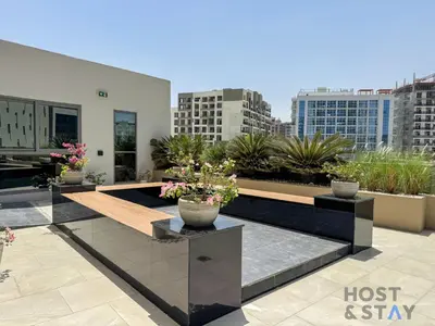 a balcony with potted plants on a building at Boho-Chic Comfort - 1BR Haven - Marquis 2020 Arjan in Dubai