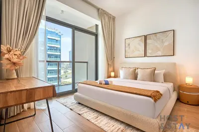 a bedroom with a large bed and a large window at Boho-Chic Comfort - 1BR Haven - Marquis 2020 Arjan in Dubai