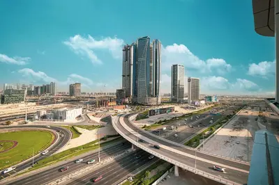 a city with traffic on a highway with tall buildings at Urban 1BR City view in The Bay Business Bay in Dubai