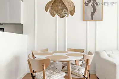 a dining room with a table and chairs at 1BR with Balcony Near Metro Station in Dubai