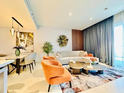 a living room with a couch and a table at Burj Khalifa View Modern 2BR CVG in Dubai