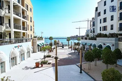 an empty street in front of a building at Luxury Escapes - Stylish 2-Bedroom Haven in La Cote, Port de La Mer in Dubai