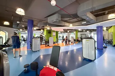 a gym with people walking and exercising in the gym at Cozy Beachside 1-bedroom in Murjan in Dubai