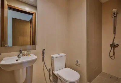 a bathroom with a toilet and a sink and a shower at Burj Khalifa View - 2BR with Maids room in Canal Front 1, Al Wasl - Allsopp & Allsopp in Dubai