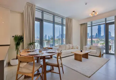 a living room with a table and a couch at Burj Khalifa View - 2BR with Maids room in Canal Front 1, Al Wasl - Allsopp & Allsopp in Dubai