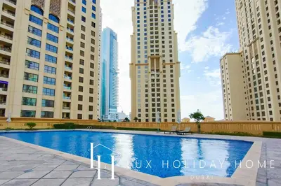 a swimming pool in the middle of some tall buildings at LUX The Murjan Sea View Suite 2 in Dubai