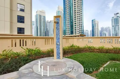 a statue in a park with a city in the background at LUX The Murjan Sea View Suite 2 in Dubai