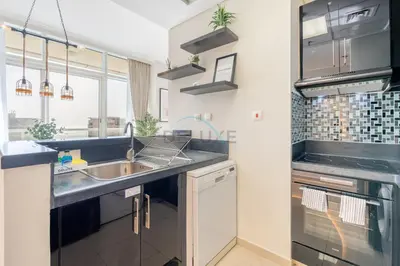 a kitchen with a sink and a stove at Sea and City View 1BR, Close to Marina Beach, Botanica Tower, Dubai Marina by Deluxe Holiday Homes in Dubai