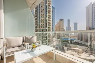 a balcony with a white table and a view of a city at Sea and City View 1BR, Close to Marina Beach, Botanica Tower, Dubai Marina by Deluxe Holiday Homes in Dubai