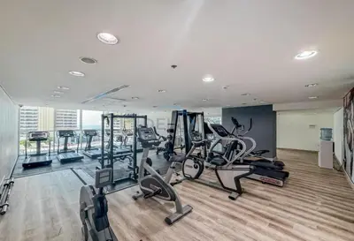 a gym with several treadmills and elliptical machines at Sea and City View 1BR, Close to Marina Beach, Botanica Tower, Dubai Marina by Deluxe Holiday Homes in Dubai