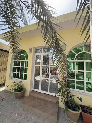 a house with a palm tree in front of it at Barsha South Cozy Guesthouse in Dubai