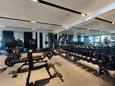 a gym with rows of chairs and weights at CaiCai Homes 1 BHK Nobles Tower Business Bay 5 min Drive to Dubai Mall in Dubai