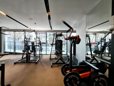 a gym with several treadmills and exercise bikes at CaiCai Homes 1 BHK Nobles Tower Business Bay 5 min Drive to Dubai Mall in Dubai