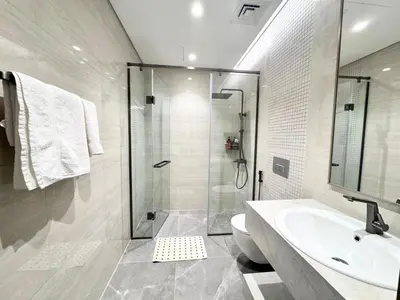 a bathroom with a shower and a toilet and a sink at CaiCai Homes 1 BHK Nobles Tower Business Bay 5 min Drive to Dubai Mall in Dubai