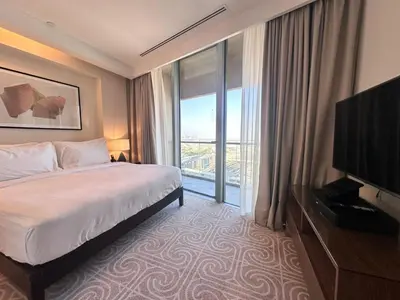 a hotel room with a bed and a large window at Durrani Homes - Dubai Mall Fashion Avenue in Dubai