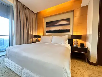 a large white bed in a room with a window at Durrani Homes - Dubai Mall Fashion Avenue in Dubai