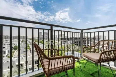a balcony with chairs and a view of the city at The Town Square Suite Luxury 2BR Near Qudra Lake in Dubai