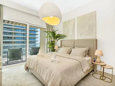 a bedroom with a large bed and a large window at Utra Lux Large 1 BR with Sunset Views and Private Beach in Dubai