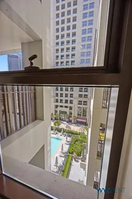 a view of a pool from a window in a building at Pink Panther Soft Glam 1BR in Surf 2-Creek Beach in Dubai