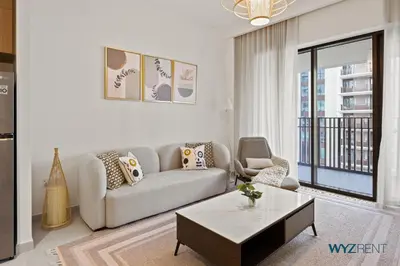 a living room with a couch and a coffee table at Earthy Elegant 1BR, Surf 2 Creek Beach Access in Dubai