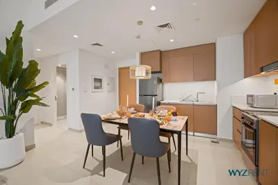a kitchen and dining room with a table and chairs at Serene 1 BR in Surf 2-Creek Beach Access in Dubai