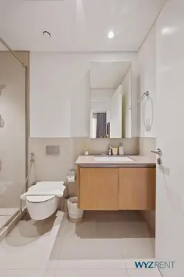 a bathroom with a toilet and a sink at Serene 1 BR in Surf 2-Creek Beach Access in Dubai