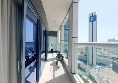 an open balcony with tables and chairs in a building at Damac Paramount Tower in Dubai
