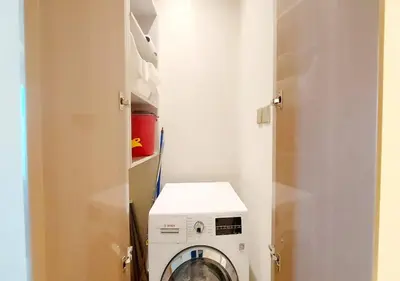 a washer and dryer in a laundry room with a door at Damac Paramount Tower in Dubai